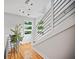 Bright hallway featuring hardwood floors, modern railing, and a unique hummingbird mobile at 670 Parker Ave, Decatur, GA 30032