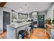 Modern kitchen featuring gray cabinets, stainless steel appliances, and a center island with bar stool seating at 670 Parker Ave, Decatur, GA 30032