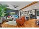 Open-concept living room flowing into a modern kitchen with hardwood floors and comfortable seating at 670 Parker Ave, Decatur, GA 30032
