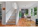 Bright living room featuring a staircase, hardwood floors, and a dining area with modern decor at 670 Parker Ave, Decatur, GA 30032