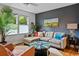 Comfortable living room featuring hardwood floors, a modern sofa and natural light from surrounding windows at 670 Parker Ave, Decatur, GA 30032
