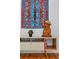 Modern living room showcasing a stylish console table with unique decor and a colorful wall hanging at 670 Parker Ave, Decatur, GA 30032
