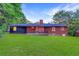 Beautiful backyard featuring a well-maintained lawn and brick home exterior at 1091 Pine St, Conyers, GA 30012