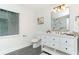 Bathroom with gray floor tiles, white cabinets, and a large mirror at 1091 Pine St, Conyers, GA 30012