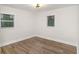 Bedroom with neutral walls, wood-look floors, and a ceiling fan light fixture at 1091 Pine St, Conyers, GA 30012