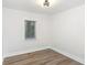 Well-lit bedroom with laminate wood floor and neutral paint at 1091 Pine St, Conyers, GA 30012