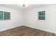 Bedroom with neutral walls, wood-look floors, and a ceiling fan light fixture at 1091 Pine St, Conyers, GA 30012