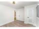 Neutral bedroom showcasing hardwood floors, two doors, and bright natural light at 1091 Pine St, Conyers, GA 30012