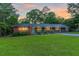 Beautiful home with a well-maintained lawn, mature trees, and an inviting facade at 1091 Pine St, Conyers, GA 30012
