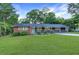 Charming single-story home with a well-maintained lawn, shrubs, and a combination brick and grey siding at 1091 Pine St, Conyers, GA 30012