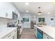 Bright, modern kitchen featuring white cabinets, stainless steel appliances, and quartz countertops at 1091 Pine St, Conyers, GA 30012