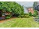 Well-manicured backyard featuring lush greenery, spiral staircase, and a charming bench, perfect for outdoor relaxation and enjoyment at 3499 Paces Ferry Se Cir, Smyrna, GA 30080
