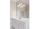 Bathroom has a vanity with drawers and a large mirror with lights at 3499 Paces Ferry Se Cir, Smyrna, GA 30080