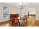 Elegant dining room featuring hardwood floors, white trim, and views into the living room at 3499 Paces Ferry Se Cir, Smyrna, GA 30080