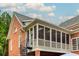 Exterior view of the enclosed porch with a spiral staircase attached at 3499 Paces Ferry Se Cir, Smyrna, GA 30080