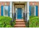 Charming entryway with blue door, brick steps, and black iron railings at 3499 Paces Ferry Se Cir, Smyrna, GA 30080