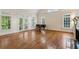 Open living room with hardwood floors, a fireplace and many windows for natural light at 3499 Paces Ferry Se Cir, Smyrna, GA 30080