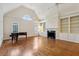 Living room with tall ceilings, hardwood floors, a fireplace and large windows at 3499 Paces Ferry Se Cir, Smyrna, GA 30080