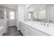 Bathroom featuring double vanity, large mirror, and glass enclosed shower at 407 Newland Way, Acworth, GA 30102