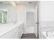 Bright bathroom featuring double sinks, white cabinets and a large mirror at 407 Newland Way, Acworth, GA 30102