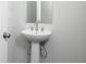 New home bathroom featuring a pedestal sink, mirror, faucet, and brushed nickel accents at 407 Newland Way, Acworth, GA 30102