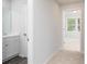 New home bathroom featuring a white vanity with a mirror and access to the bedroom at 407 Newland Way, Acworth, GA 30102