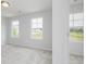 Bright bedroom with neutral carpet and two windows offering neighborhood views at 407 Newland Way, Acworth, GA 30102