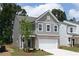Charming two-story home featuring a gray exterior, brick accents, and a two-car garage at 407 Newland Way, Acworth, GA 30102