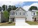 Charming two-story home featuring a gray exterior, brick accents, and a two-car garage at 407 Newland Way, Acworth, GA 30102