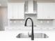 Modern kitchen island featuring a stainless steel sink with black faucet and quartz countertop at 407 Newland Way, Acworth, GA 30102