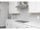 Close up of modern kitchen features, including stainless steel range hood and gray backsplash at 407 Newland Way, Acworth, GA 30102