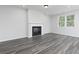 Cozy living room with fireplace, neutral colors, and wood-look flooring at 407 Newland Way, Acworth, GA 30102