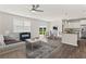 New living space featuring an open floor plan, large window, kitchen, and hardwood flooring at 407 Newland Way, Acworth, GA 30102