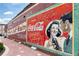 Vintage Coca-Cola advertisement painted on brick wall with fading colors at 407 Newland Way, Acworth, GA 30102