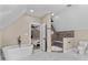 Bright bathroom featuring a soaking tub, walk-in shower, and marble tile flooring next to the bedroom at 1066 Fairway Valley Dr, Woodstock, GA 30189