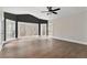 Bright bedroom with hardwood floors, large windows with views, and a ceiling fan at 1066 Fairway Valley Dr, Woodstock, GA 30189