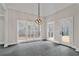 Bright breakfast nook has large windows with views, stylish lighting, and a glass door to a deck at 1066 Fairway Valley Dr, Woodstock, GA 30189