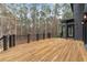 Wooden deck featuring dark accents overlooking a wooded landscape at 1066 Fairway Valley Dr, Woodstock, GA 30189