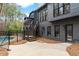 Dark home exterior featuring a multi-level deck with steps down to a fenced-in pool and patio at 1066 Fairway Valley Dr, Woodstock, GA 30189