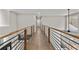 Hallway with hardwood floors and decorative railing at 1066 Fairway Valley Dr, Woodstock, GA 30189