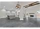 Open floor plan showcasing the kitchen, stone tile flooring, fireplace, and stairs with metal railing at 1066 Fairway Valley Dr, Woodstock, GA 30189