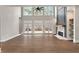 Bright and airy living room featuring hardwood floors, large windows, and a modern fireplace with built-in shelves at 1066 Fairway Valley Dr, Woodstock, GA 30189