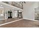 Expansive living space with hardwood floors, modern lighting, and staircase with wood and metal railings at 1066 Fairway Valley Dr, Woodstock, GA 30189