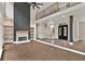 Open-concept living space with hardwood floors, modern fireplace, and staircase with wood and metal railings at 1066 Fairway Valley Dr, Woodstock, GA 30189