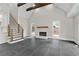 Living room featuring fireplace, stairs with metal railing, wood beams, and stone tile flooring at 1066 Fairway Valley Dr, Woodstock, GA 30189