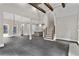 Spacious open floor plan with a view of the kitchen, stairs, living room, and stone tile flooring at 1066 Fairway Valley Dr, Woodstock, GA 30189