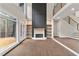 Bright and airy living room featuring hardwood floors, large windows, and a modern fireplace with built-in shelves at 1066 Fairway Valley Dr, Woodstock, GA 30189