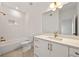 Modern bathroom featuring white vanity, bright lighting and white subway tile with bronze fixtures at 1836 Memorial Dr # 303, Atlanta, GA 30317