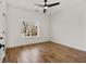 Empty bedroom with hardwood floors, white walls, ceiling fan and a large window at 1836 Memorial Dr # 303, Atlanta, GA 30317