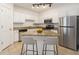 Well-lit kitchen boasts an island with seating, stainless steel appliances, and ample counter space at 1850 Cotillion Dr # 4218, Atlanta, GA 30338